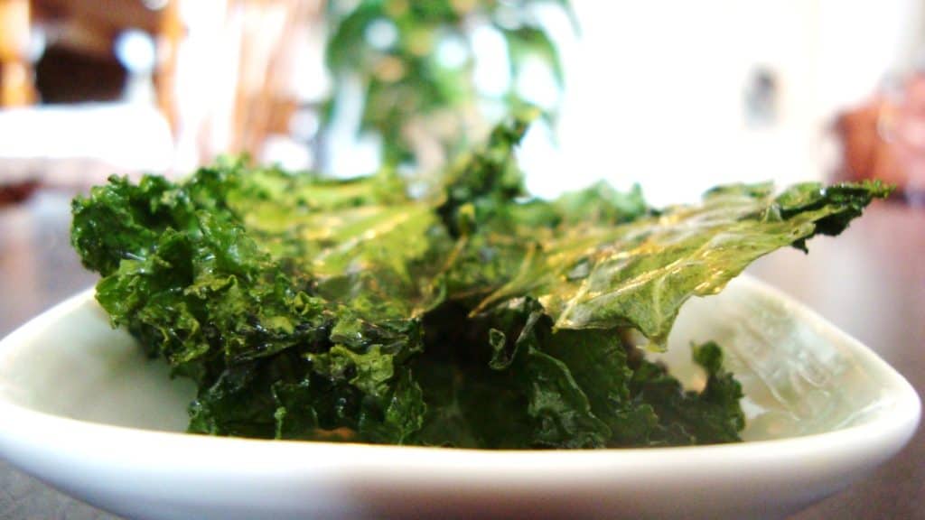 Upclose photo of kale chips on a plate. 
