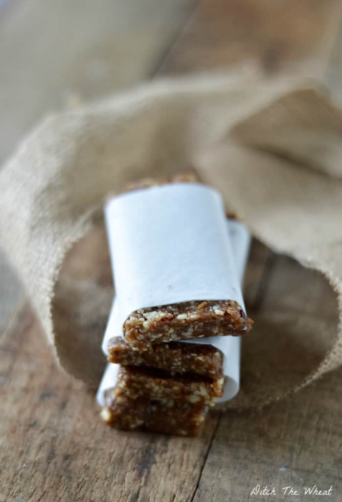 Stacked Pecan Pie Larabars on a wooden background. 