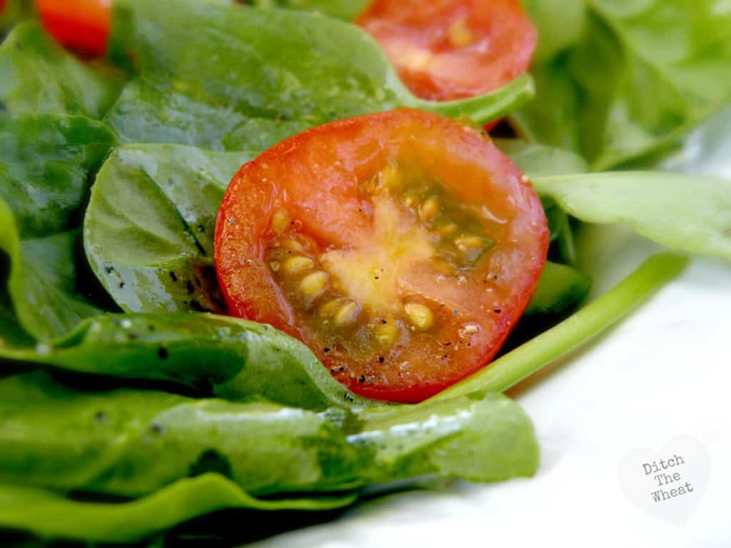 simple salad dressing on lettuce and a tomato