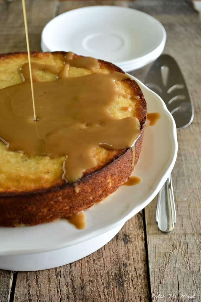 Paleo Plantain Cake with caramel sauce and on a cake platter.
