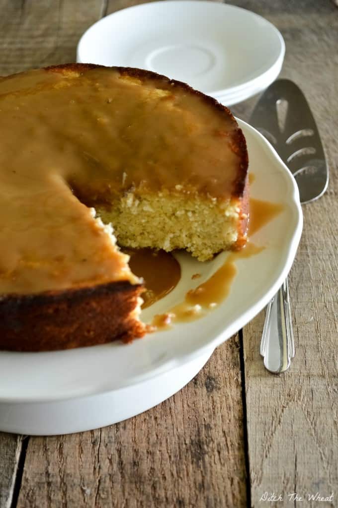Paleo Plantain Cake with caramel sauce and on a cake platter.