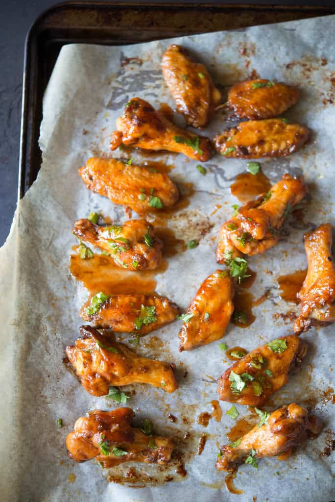 Sriracha chicken wings on parchment paper