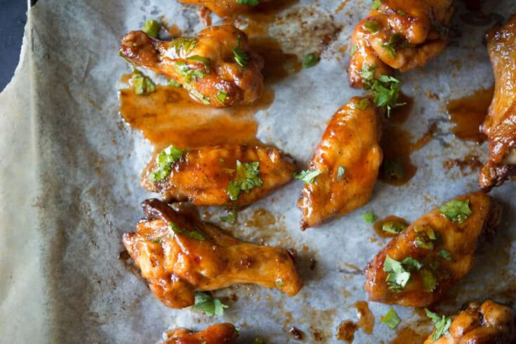 Sriracha chicken wings on parchment paper