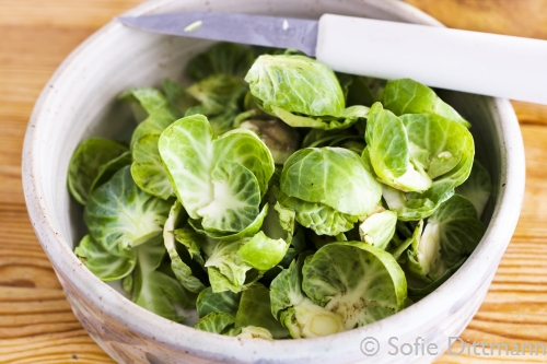 A bowl filled with the outer leaves of the Brussels sprouts.