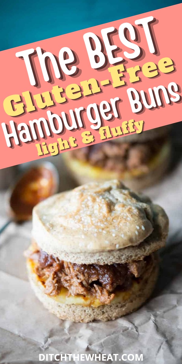 A Gluten-Free Hamburger Bun that is filled with pulled pork with a spoon that has sauce.