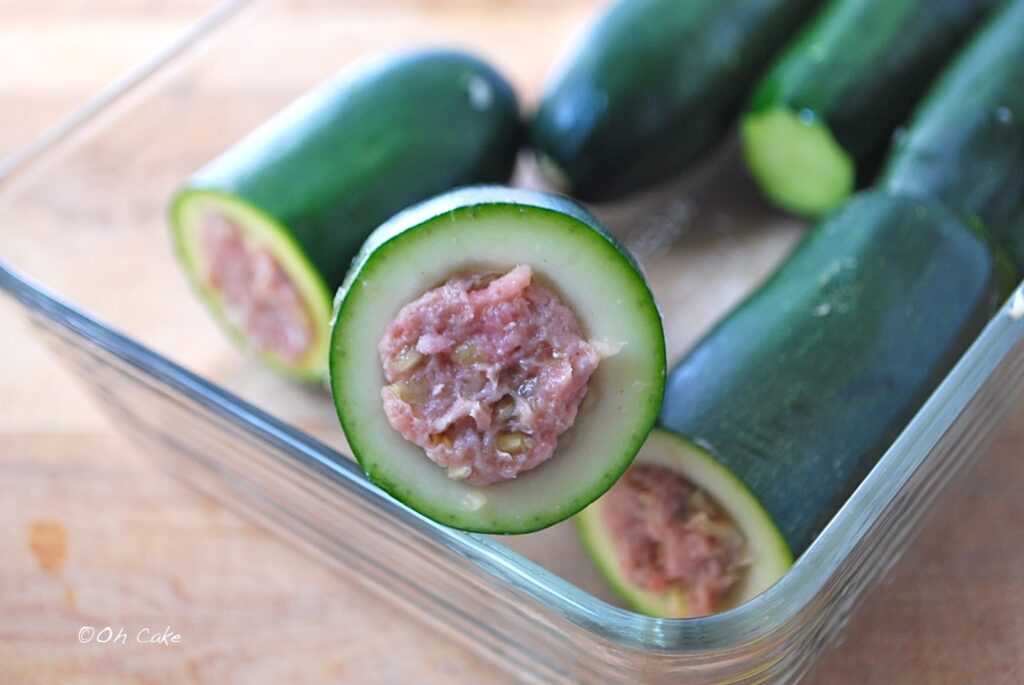 Keto stuffed zucchini in a dish that needs to be baked.