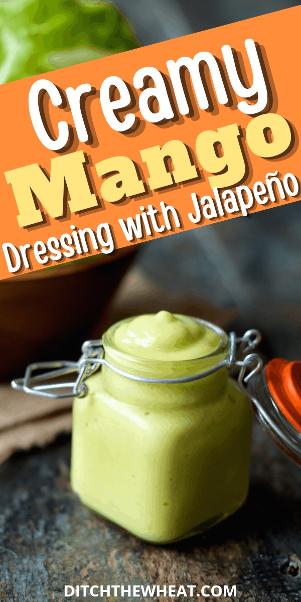 A little glass jar filled with creamy mango salad dressing.