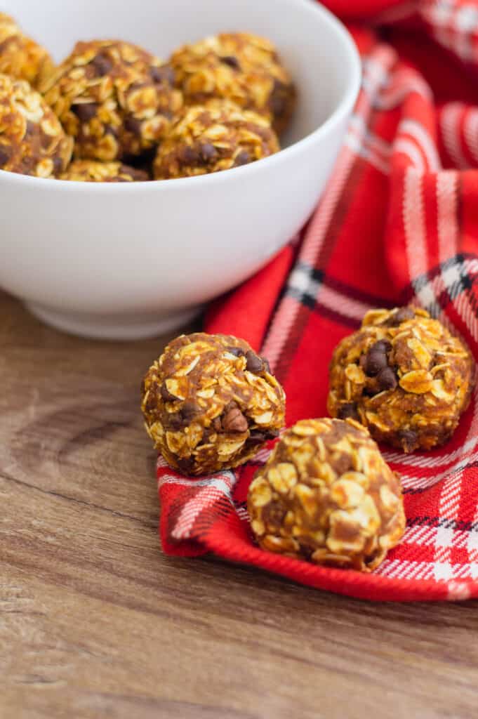Pumpkin Protein Balls in a bowl and on a napkin