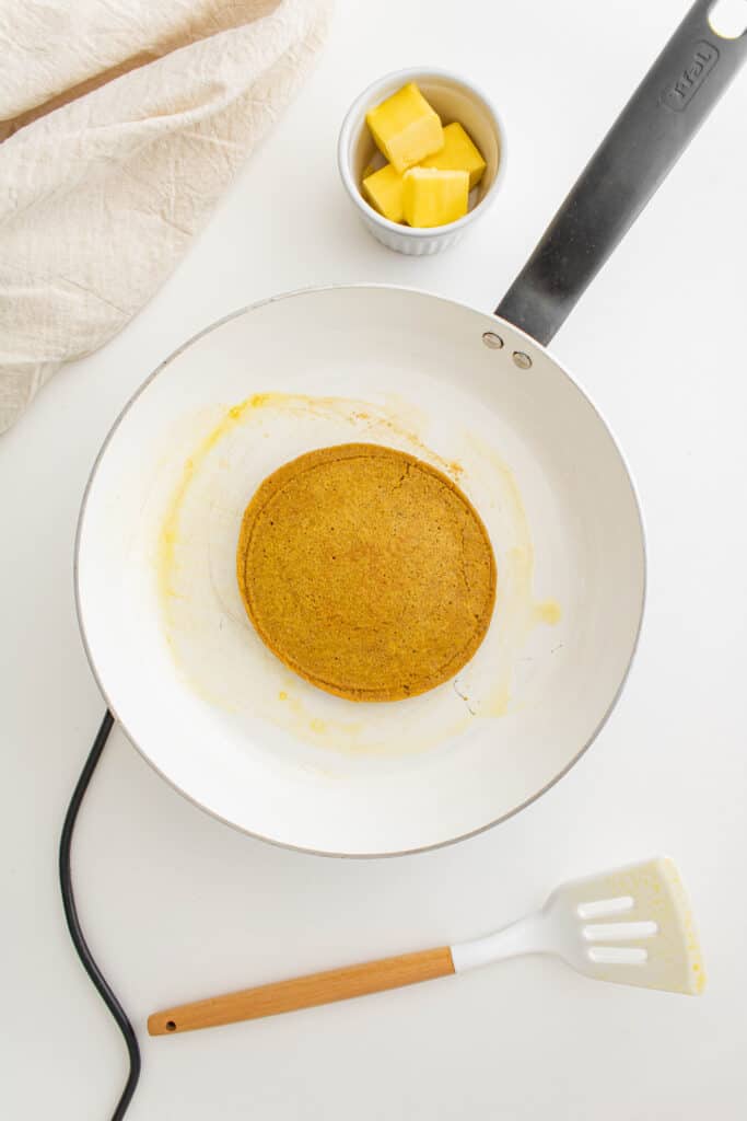 Pumpkin oatmeal pancakes in a frying pan. 
