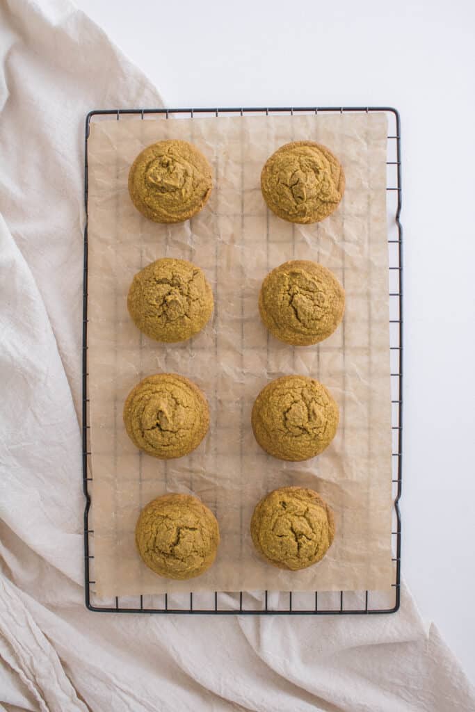 Oat flour pumpkin muffins on a cooling rack.