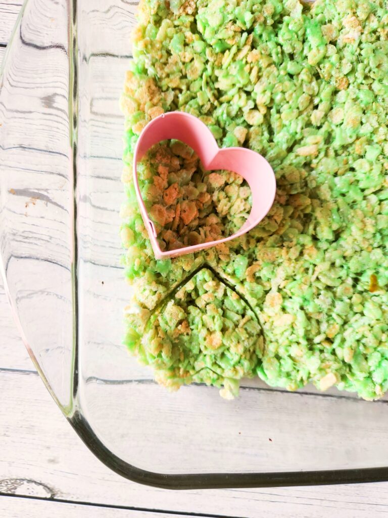 Cutting out grinch rice krispie treats.