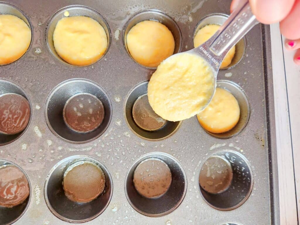gluten free corn dog muffins - Filling the muffin tin with corn dog batter.