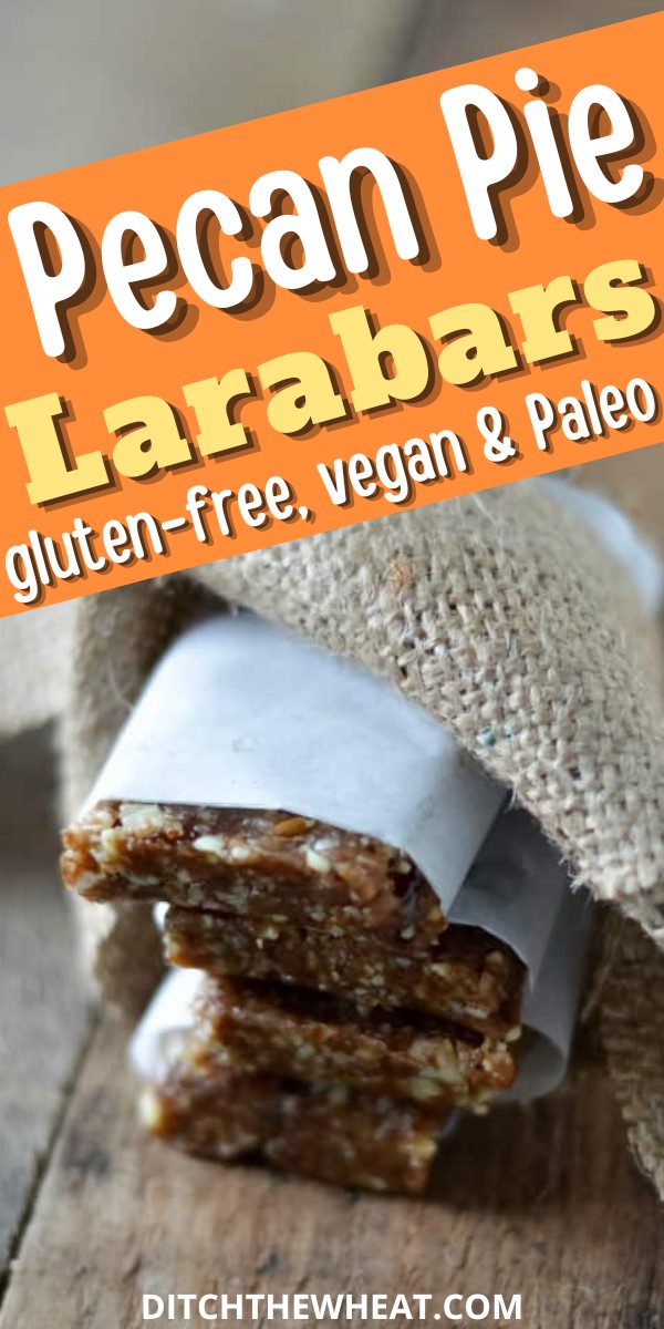 A stack of pecan pie larabars that are wrapped in parchment paper with a piece of fabric.