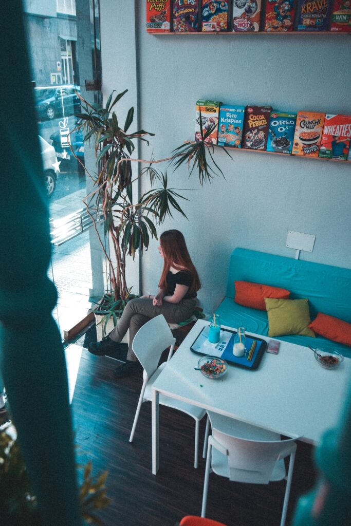 A woman sitting in a cereal bar.