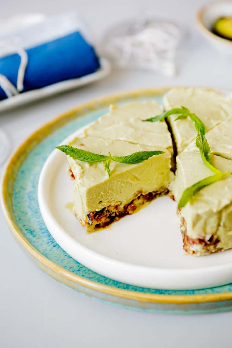 An avocado cheesecake cut into slices.