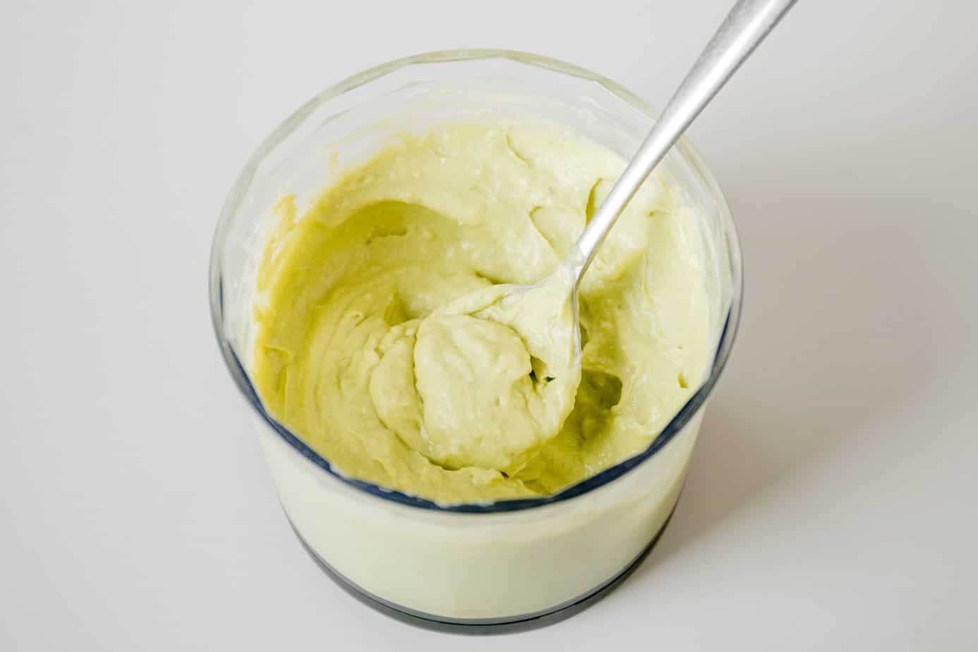 The blended avocado mixture with a spoon.