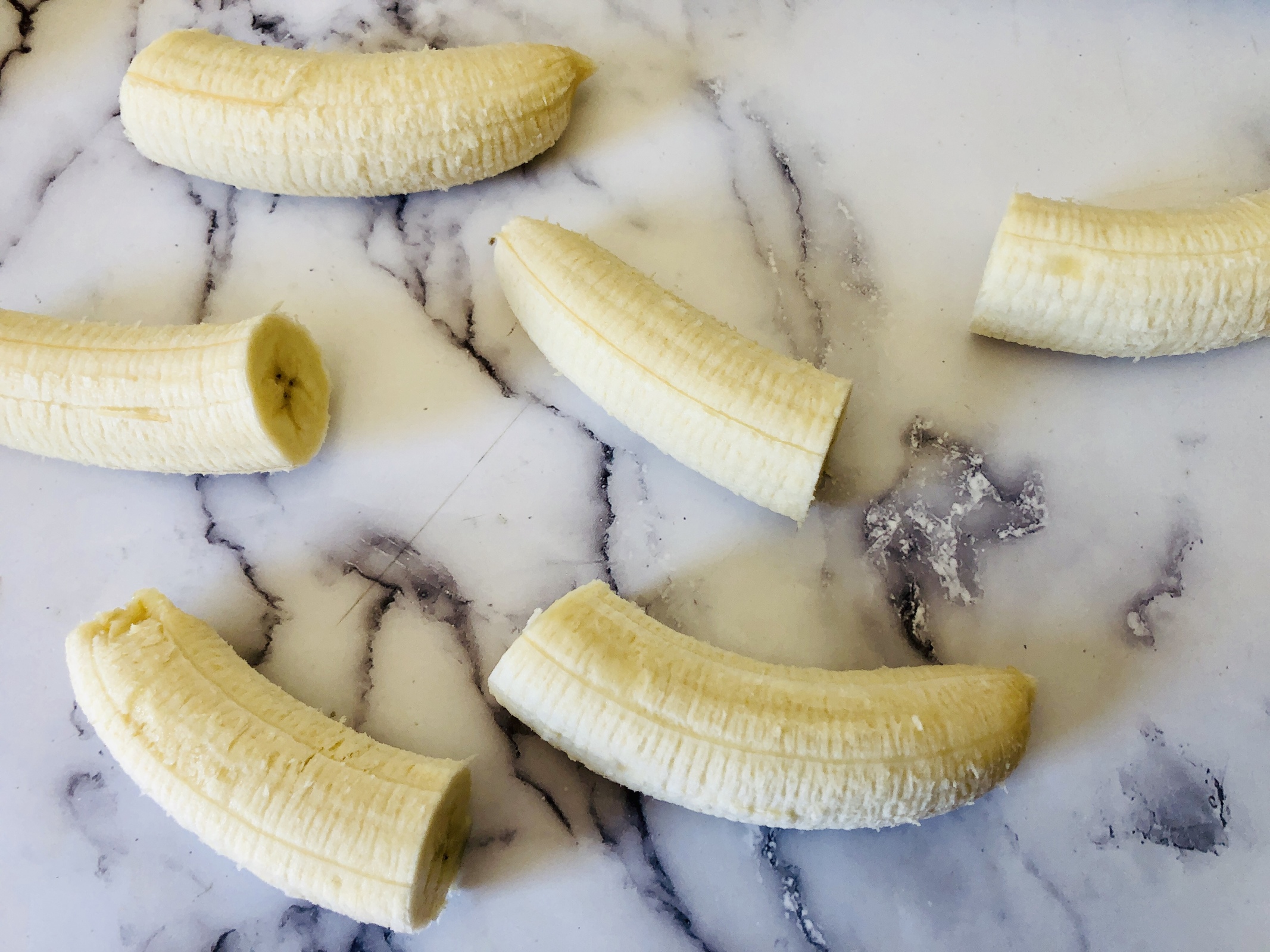 Bananas without the peel cut in half. 