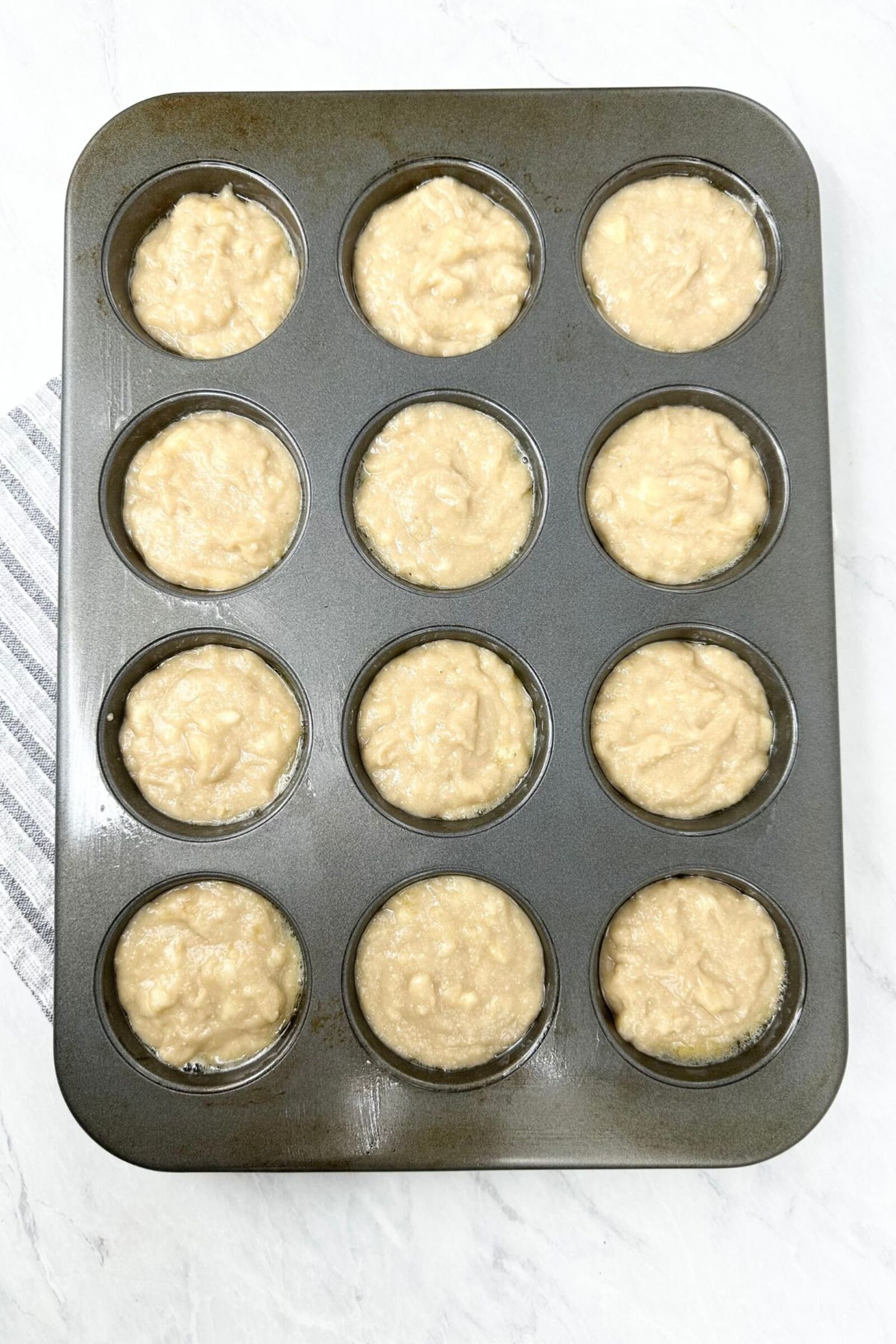 Cassava Flour Banana Muffins unbaked in a muffin pan.