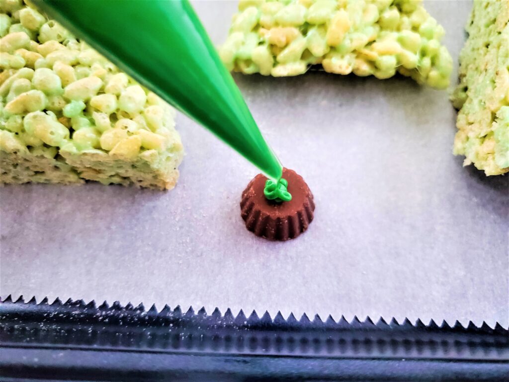 Placing green candy melts on chocolate.