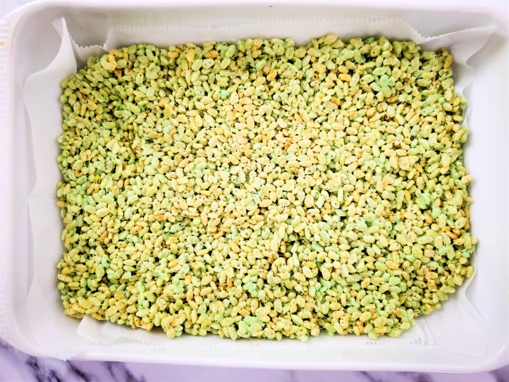 Green rice krispies in a baking dish.