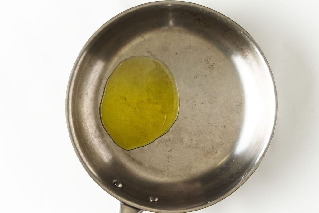 Heating a pan with oil.