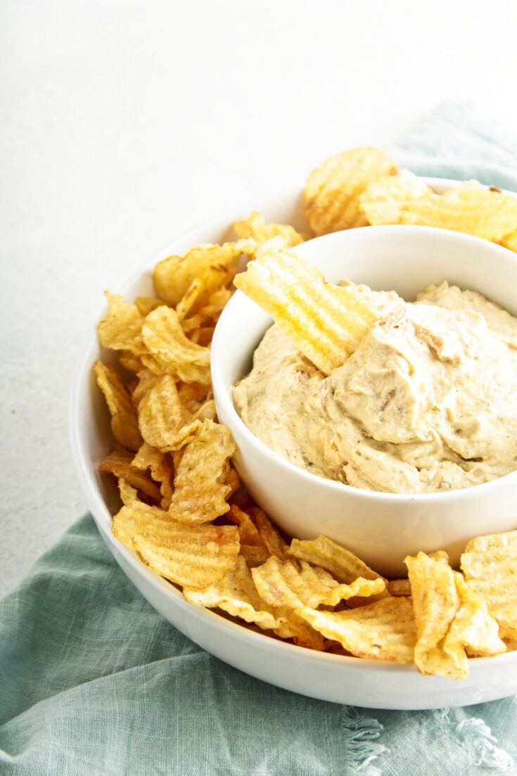 Dairy Free Caramelized Onion Dip in a bowl with chips.
