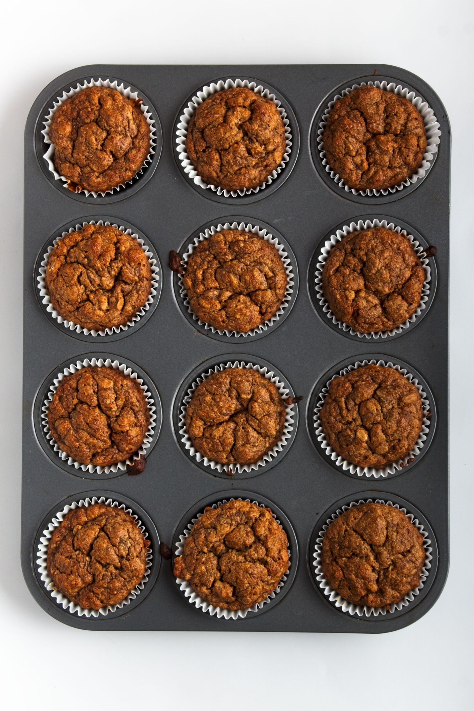 Baked Oat Flour Banana Muffins in a muffin pan.
