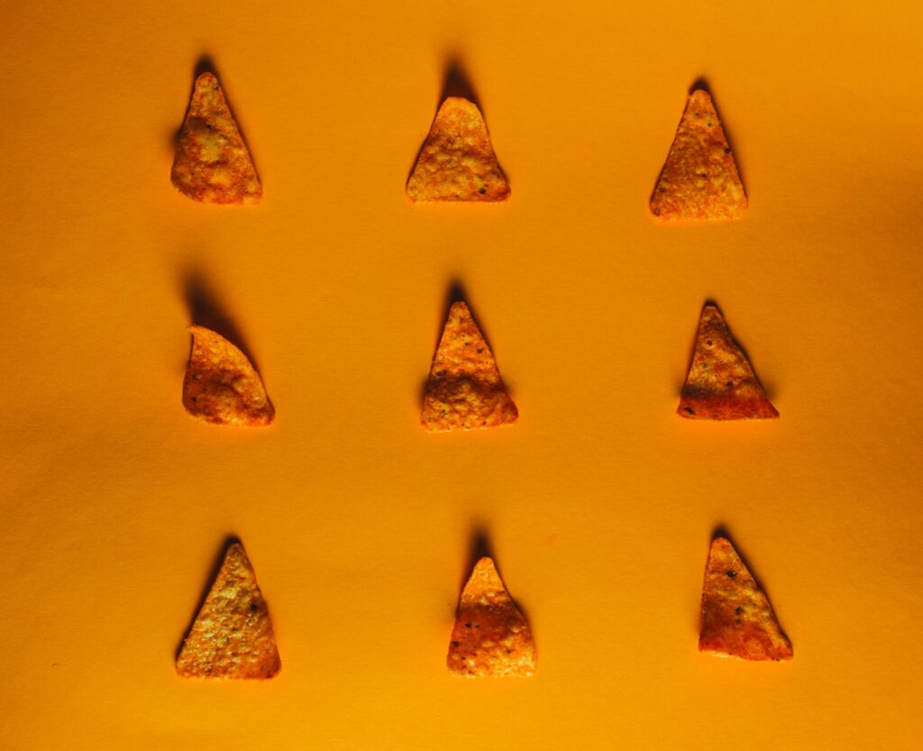 Are Doritos Gluten Free? An image of doritos on an orange background.