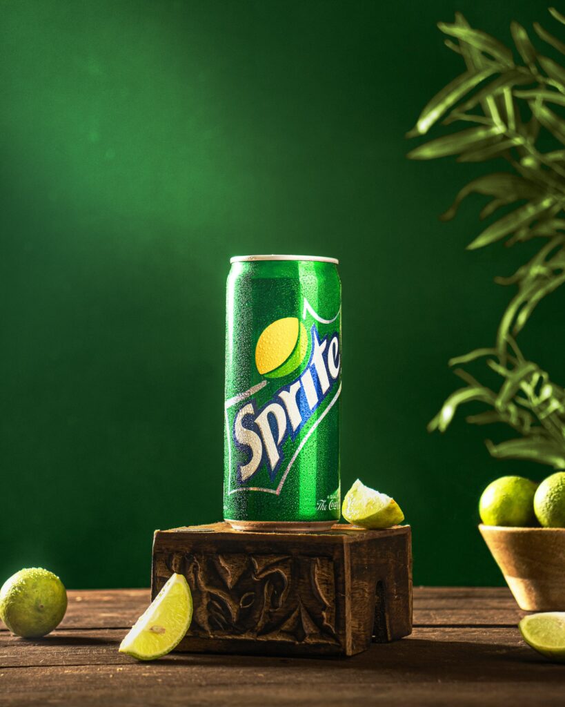Is Sprite Gluten Free? A can of Sprite on a block of wood with limes around it. 