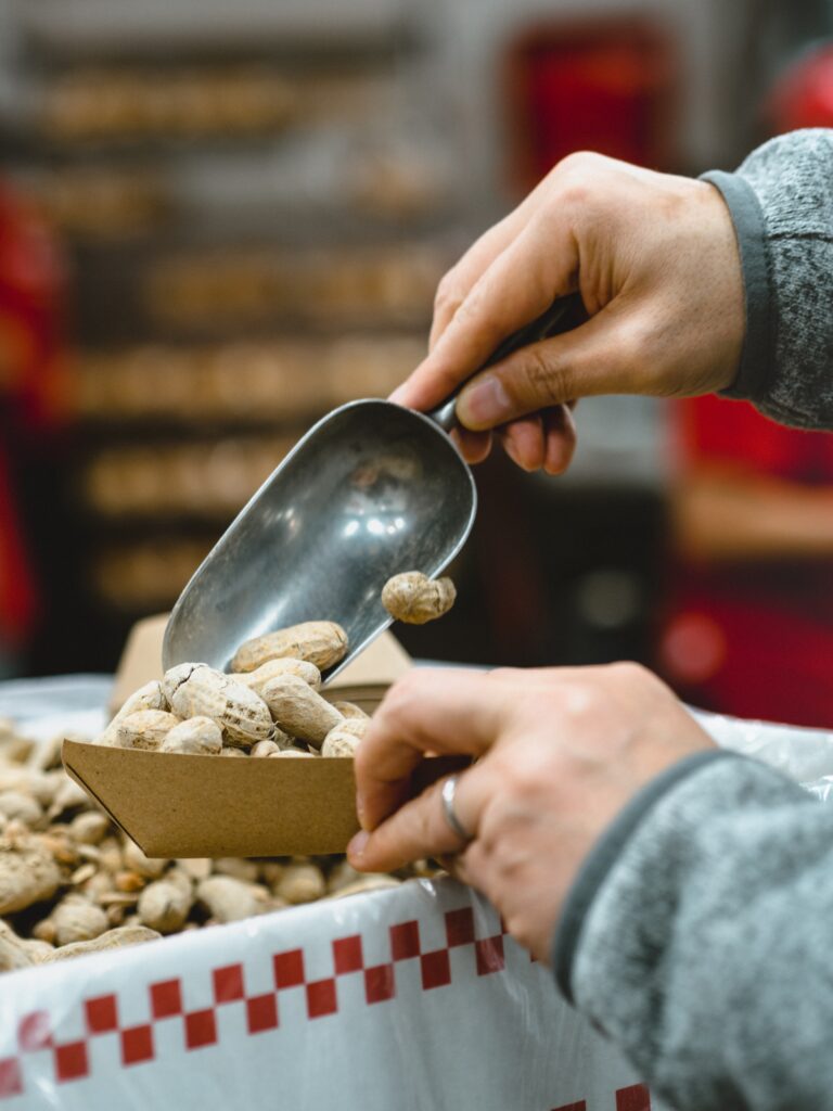 Are peanuts gluten free? Peanuts being scooped into a container.