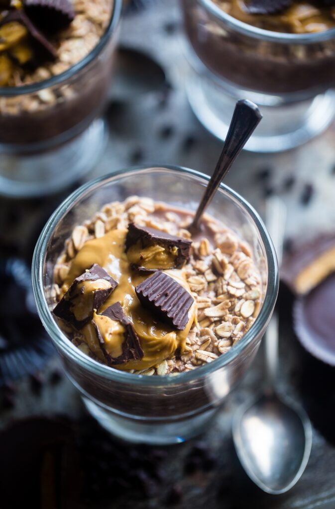 Does Almond Butter Go Bad? A glass of oats, almond butter, and chocolate cups.