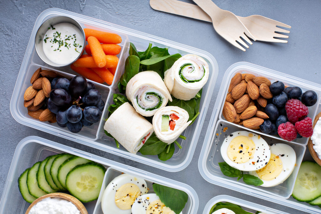 Gluten Free Lunch Ideas For Kids. 4 lunch boxes filled with food.