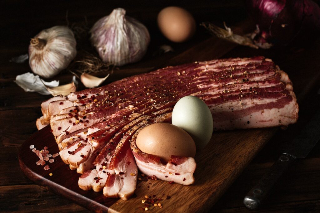 Is Bacon Gluten free? Uncooked bacon with eggs and garlic.