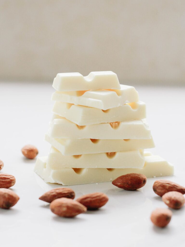 Is White Chocolate Gluten Free? A pile of white chocolate with almonds.