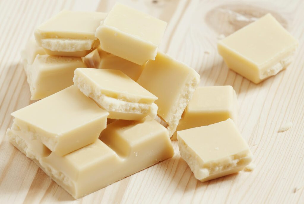 Is White Chocolate Gluten Free? A pile of broken pieces of white chocolate.