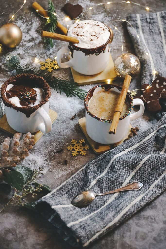 3 mugs of hot chocolate with toppings.