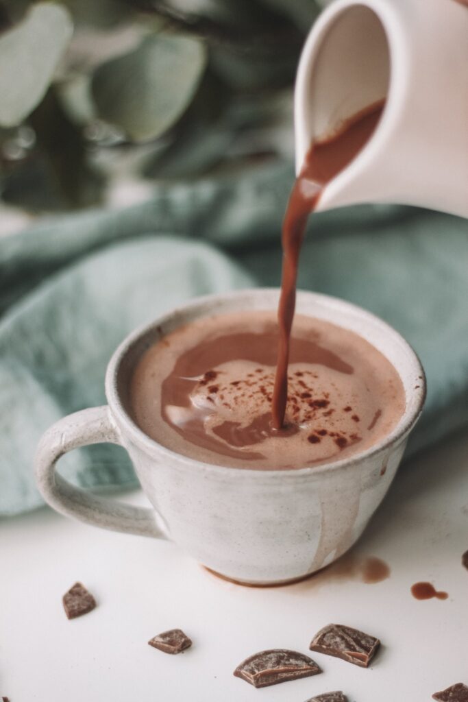 Hot chocolate being poured into a mug.