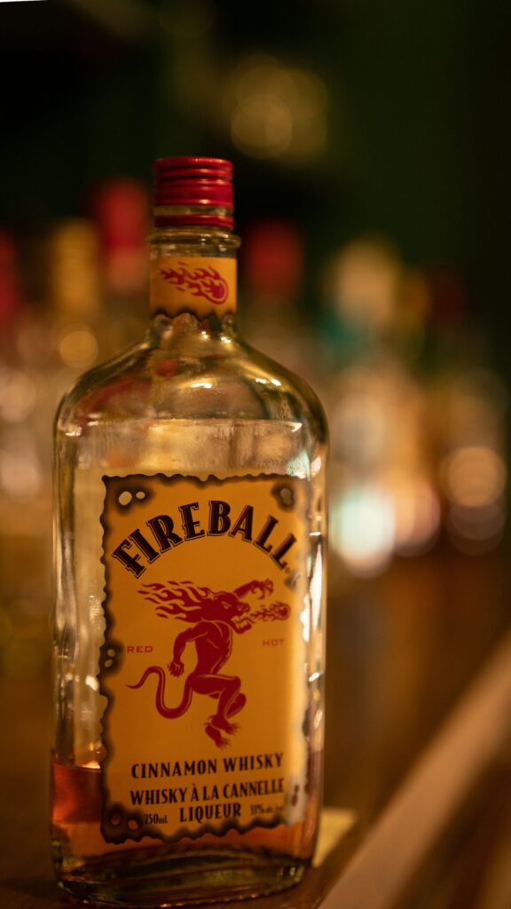 A bottle of Fireball in a dark setting.
