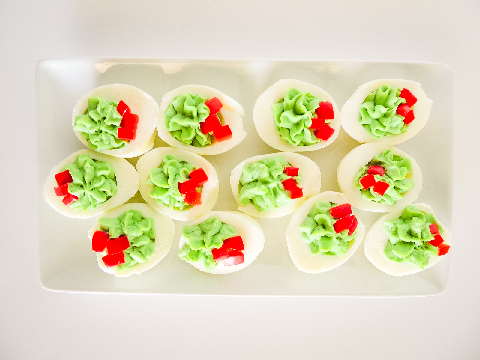 A tray with decorated Christmas Deviled Eggs.