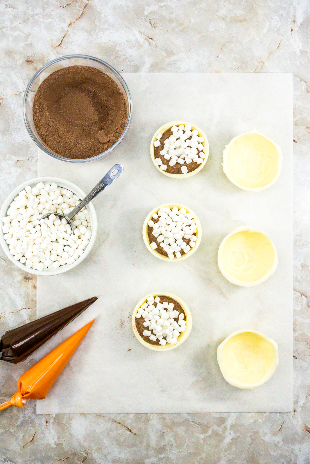 White chocolate spheres filled with hot chocolate mix and marshmallows.