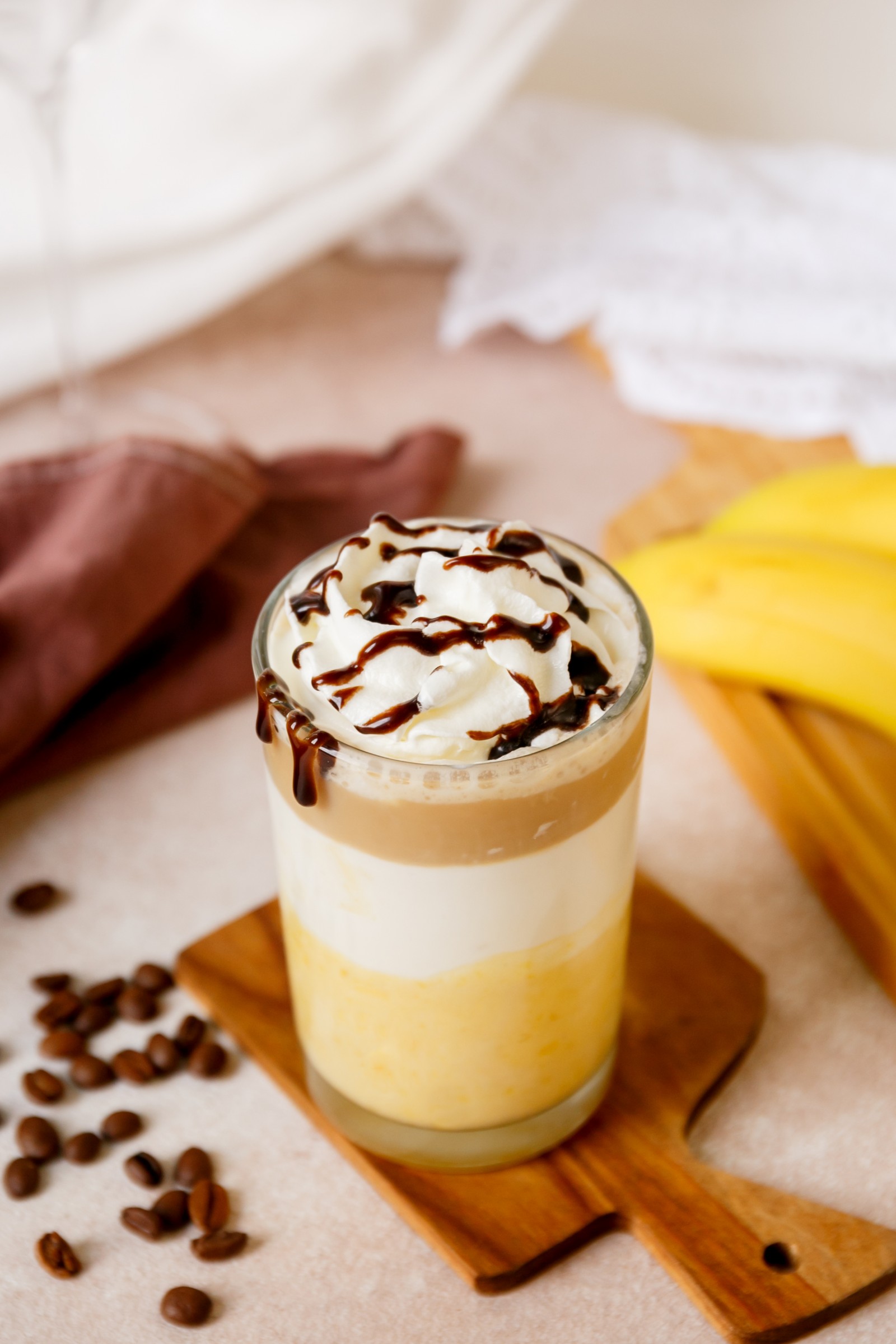 A glass filled with a Starbuck's copycat banana Split Frappuccino.