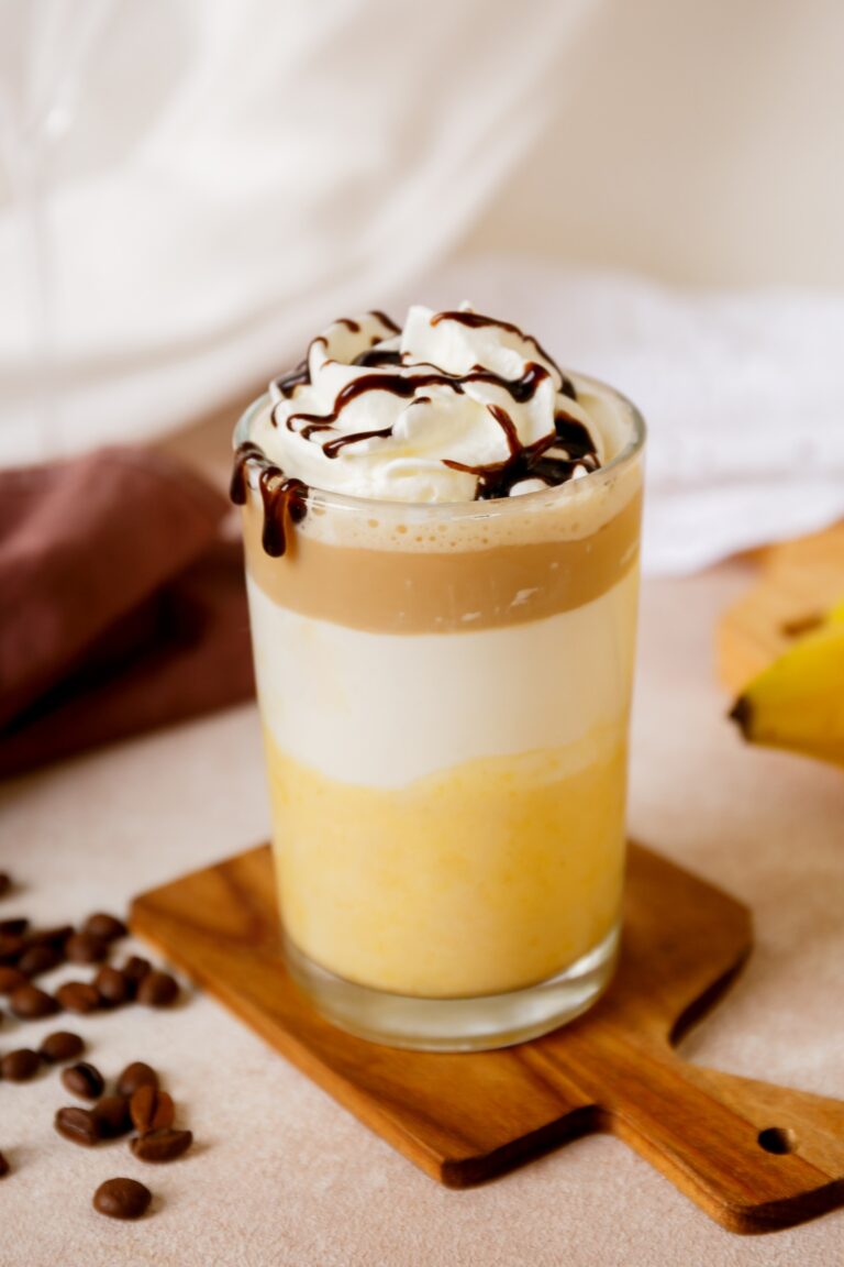 A glass filled with a Starbuck's copycat banana Split Frappuccino.