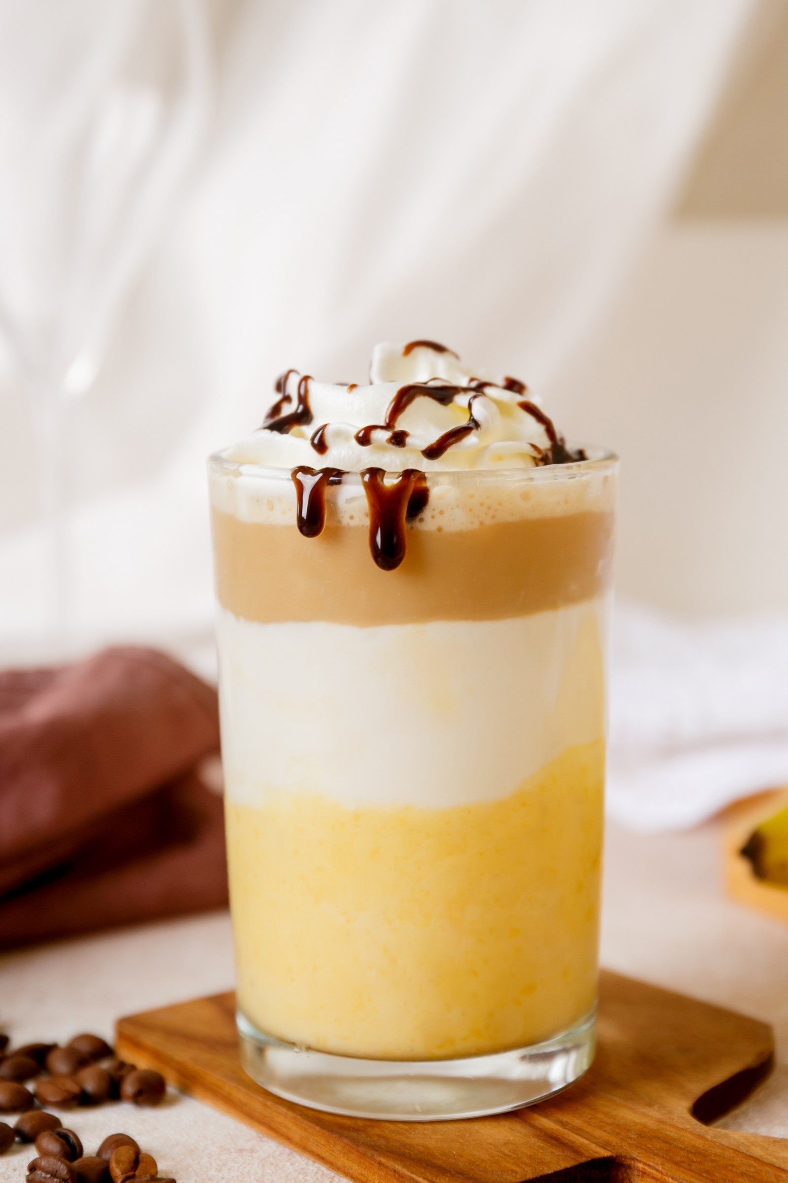 A glass filled with a Starbuck's copycat banana Split Frappuccino.
