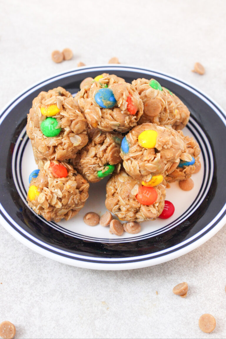 A plate with a blue rim that is filled with monster energy balls.