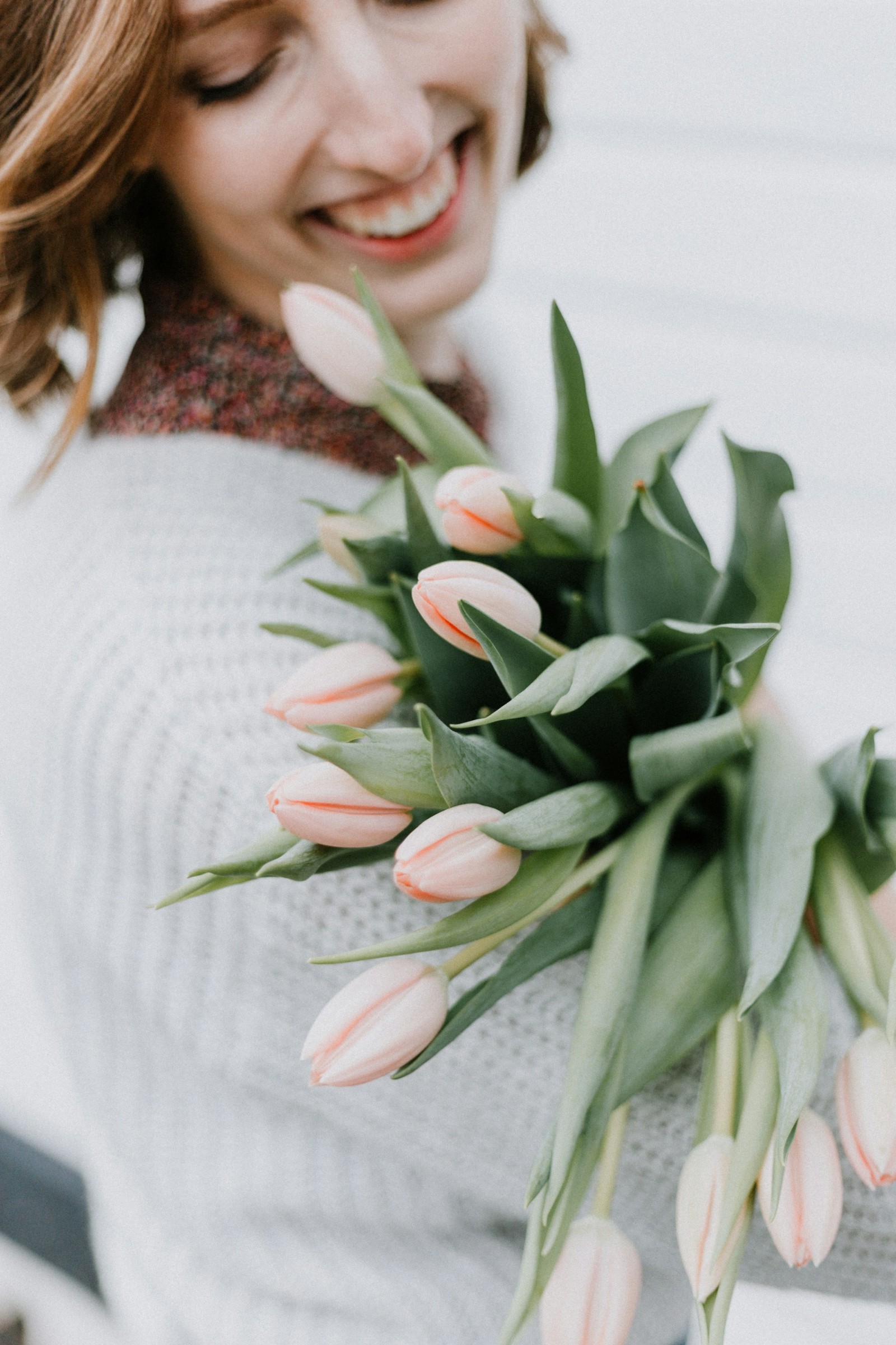A woman holding tulips.