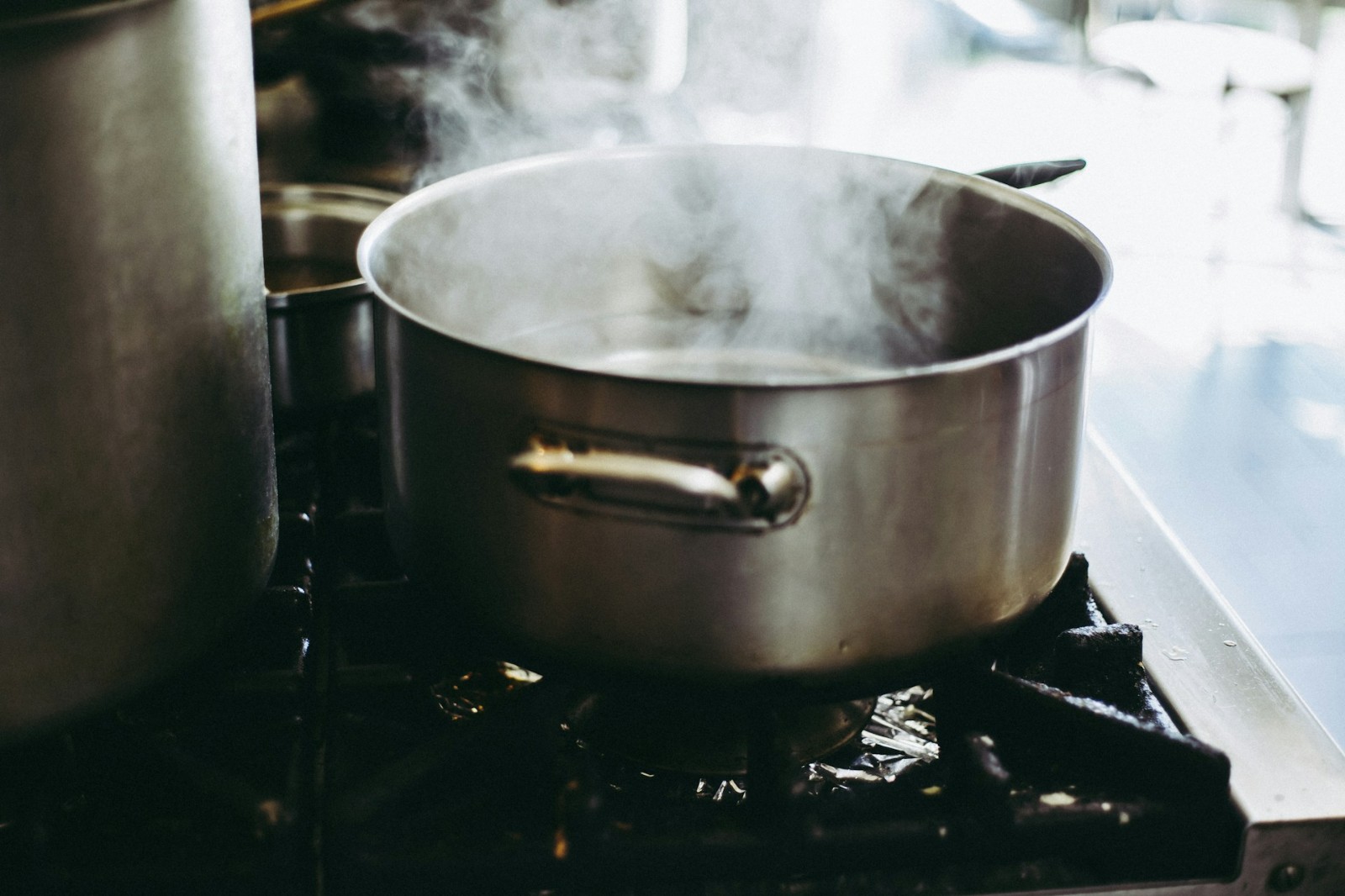 A large pot of boiling water on a stove top.