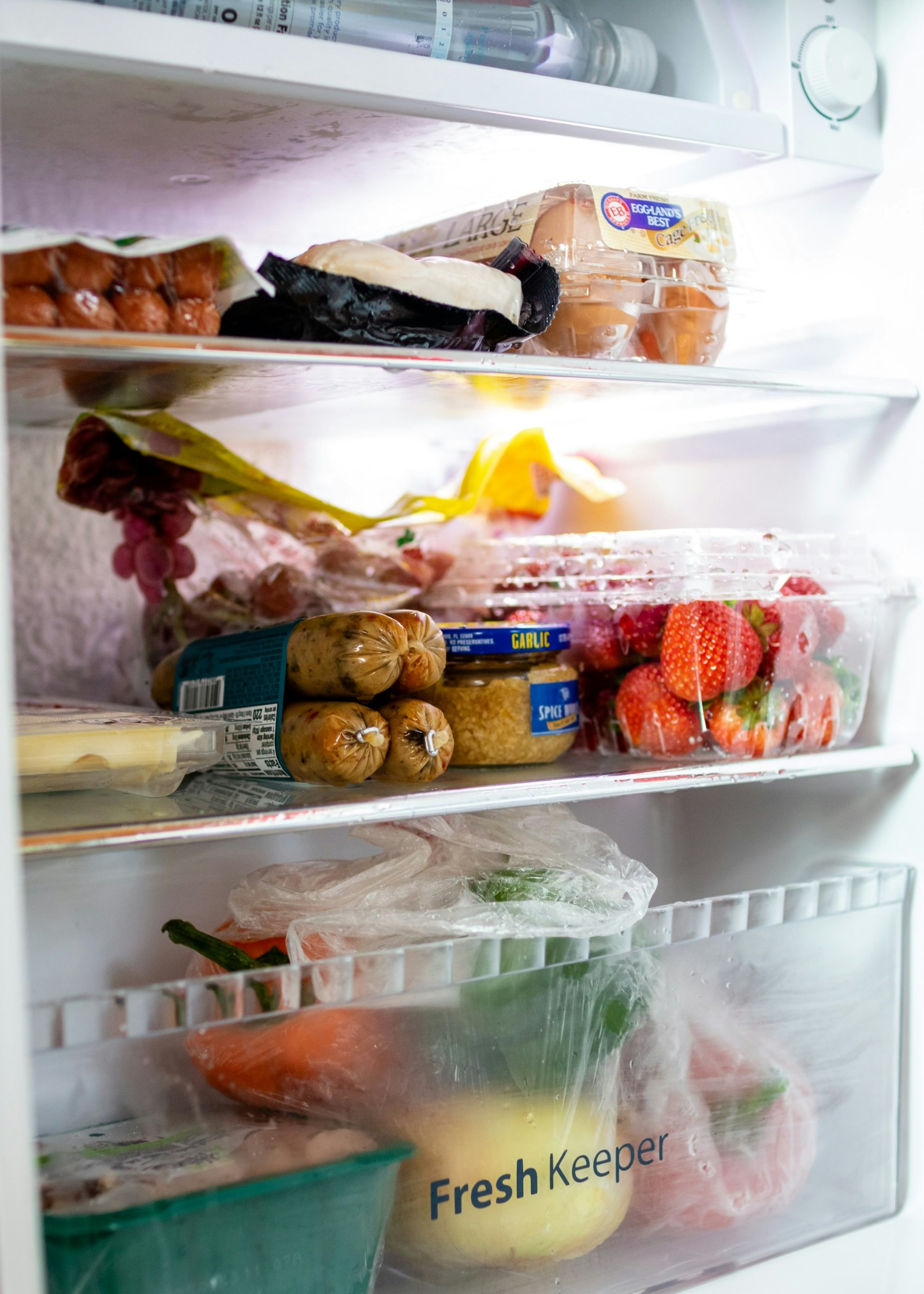 The inside of a fridge that is filled with various food.