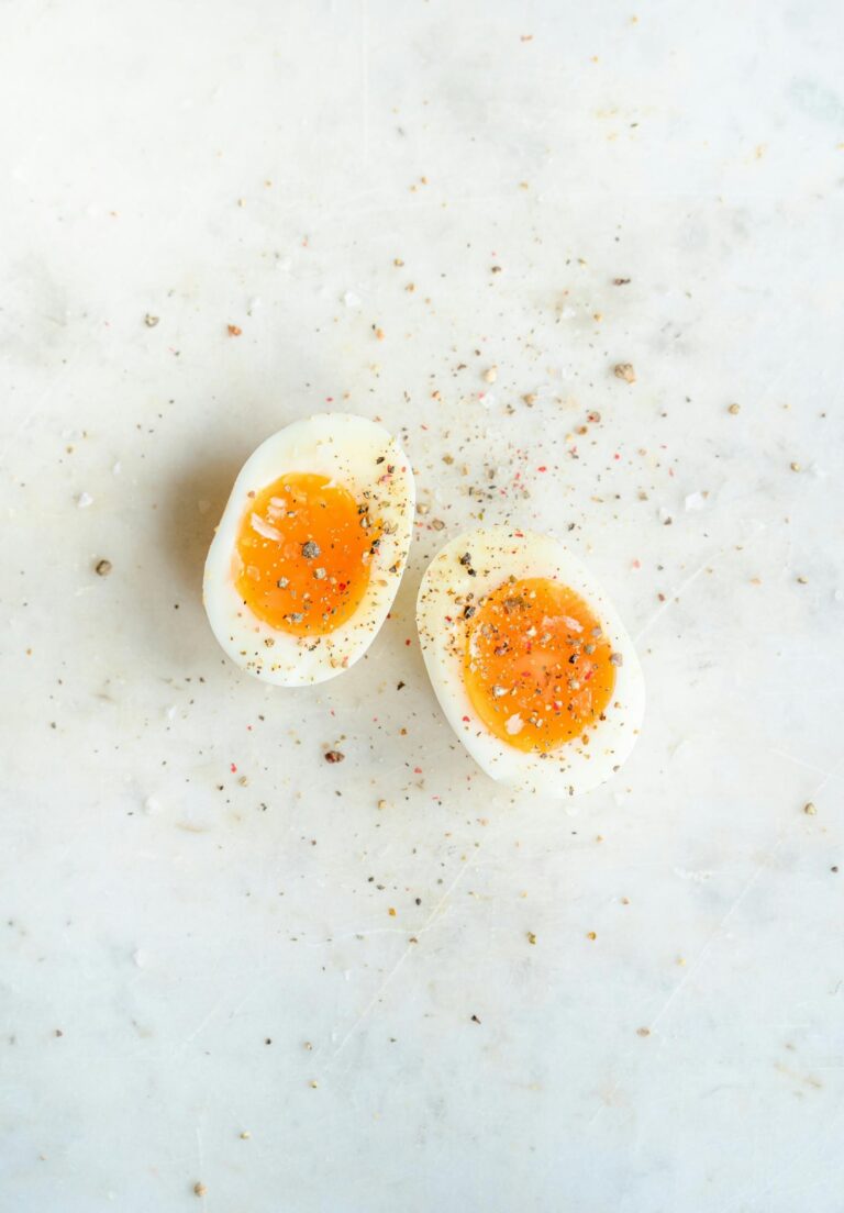 A boiled egg that is cut in half with a jammy center.