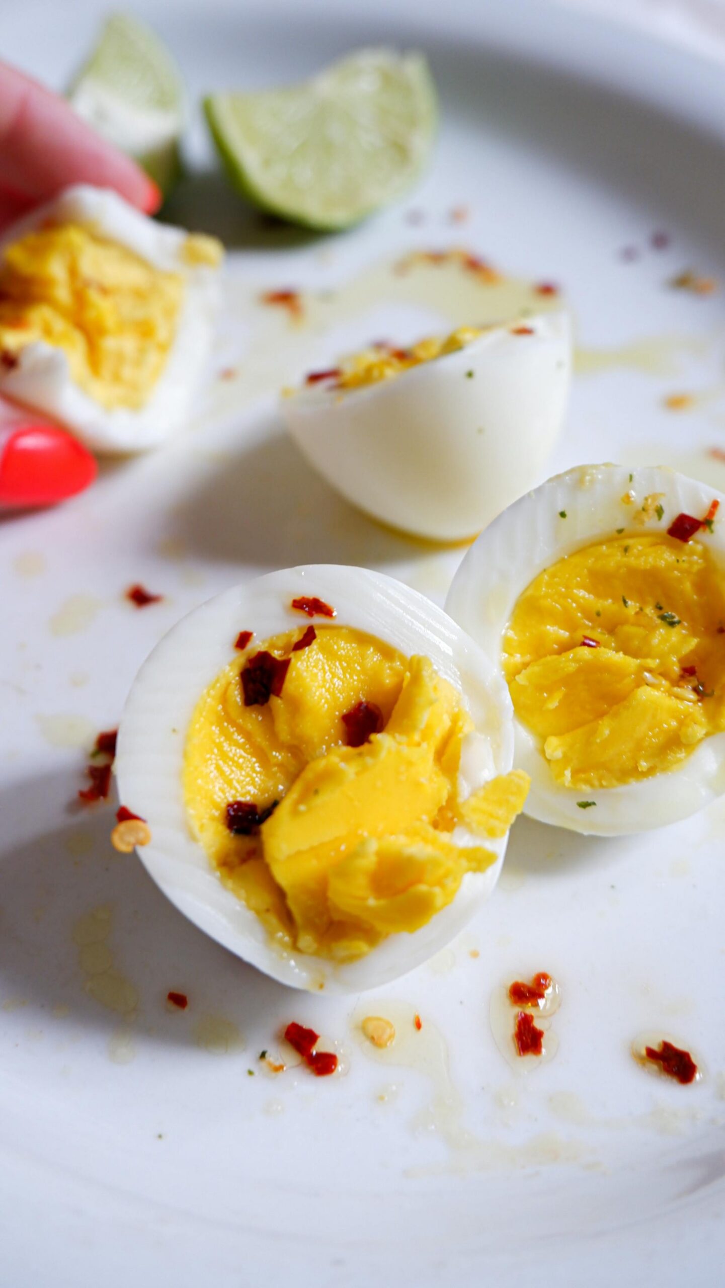 Boiled eggs cut in half with red pepper flakes.