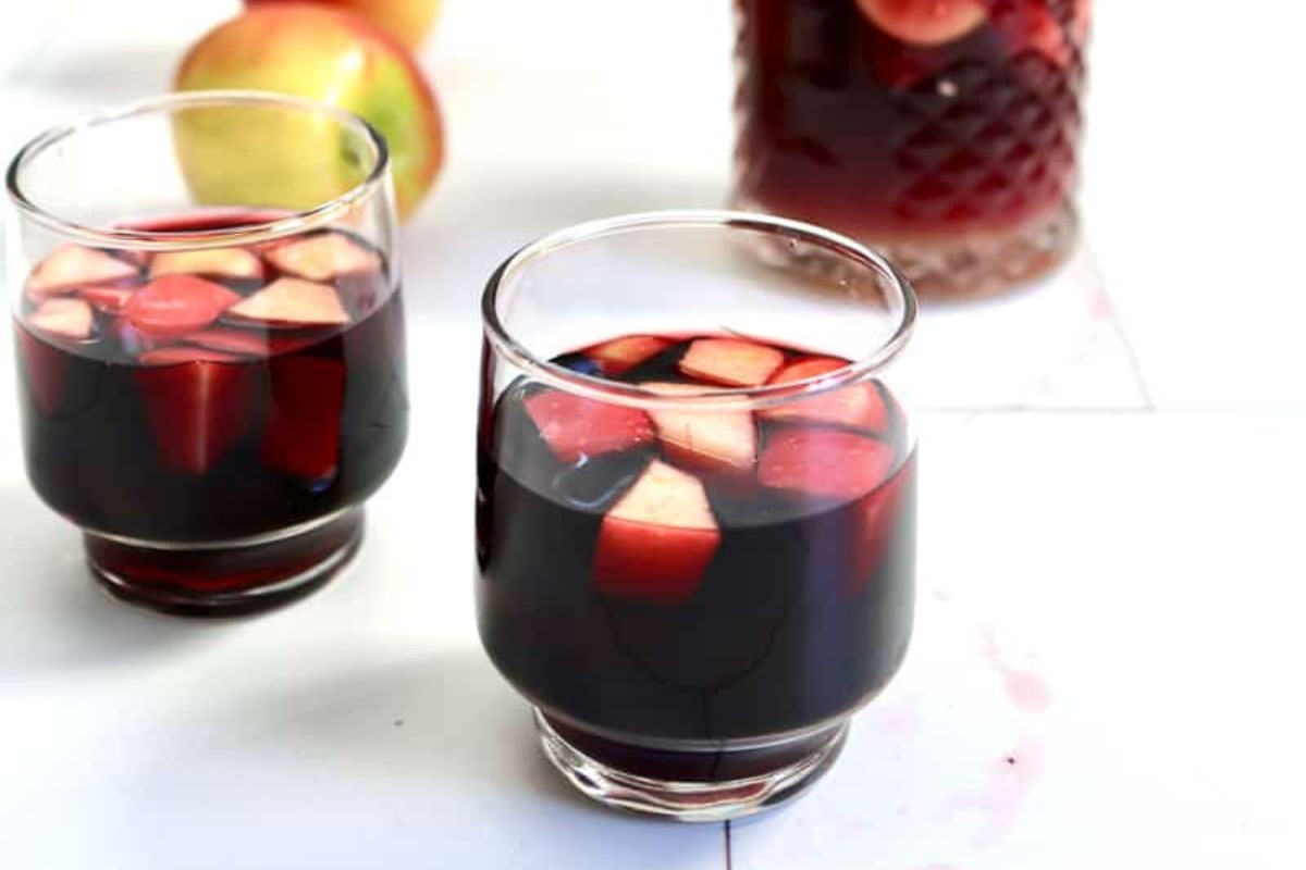 Three glass filled with apple cider sangria.